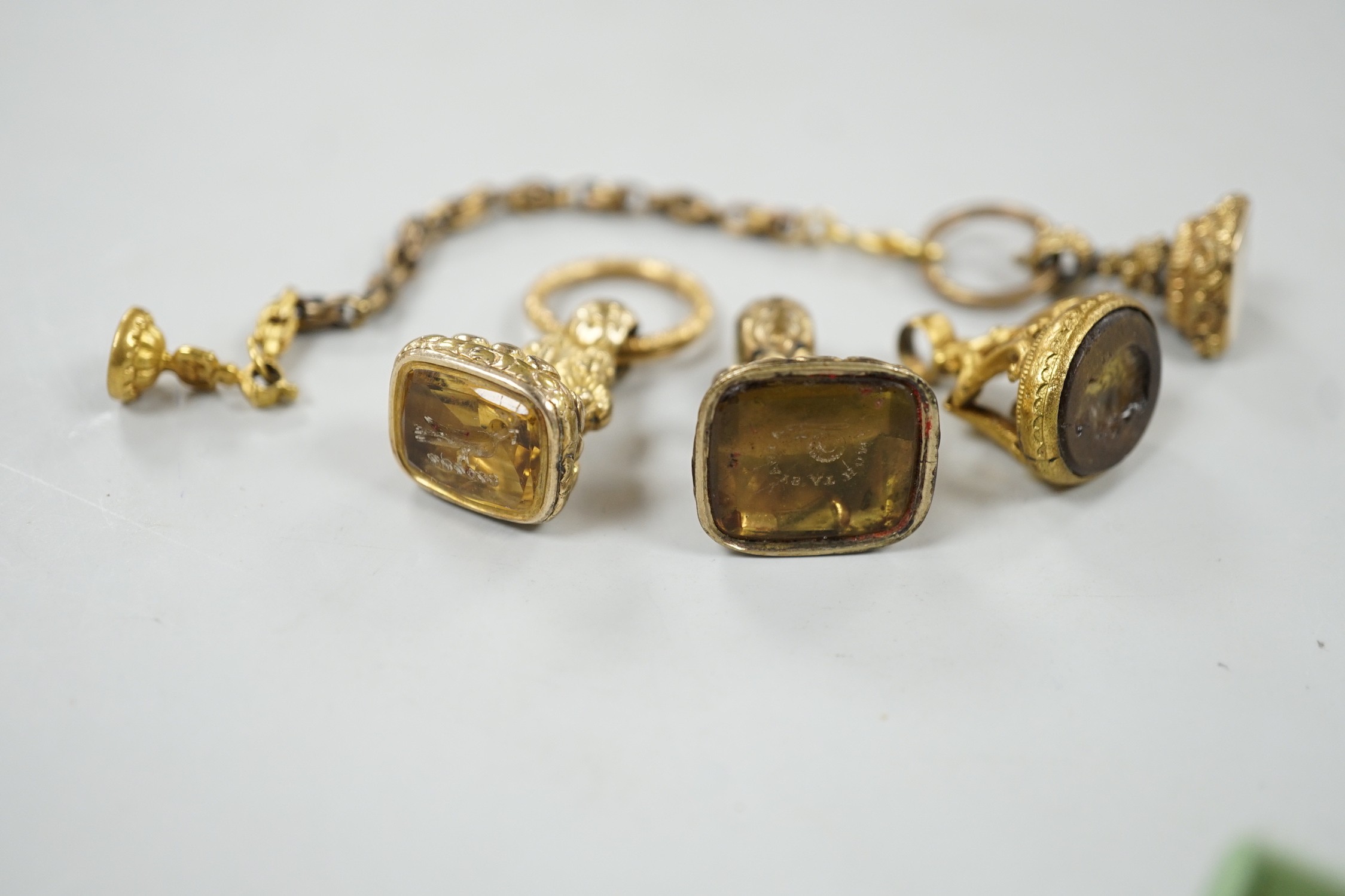 Four assorted 19th century gold plated fob seals, set with citrine, glass or carnelian, largest 30mm.